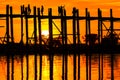 Panorama of the U Bein Bridge built from teak at Mandalay in Myanmar at sunset in the backlight Royalty Free Stock Photo