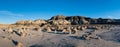 Panorama of unusual rocks and boulders scattered across the floor of a barren desert Royalty Free Stock Photo