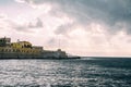 Panorama venetian harbour waterfront and Lighthouse in old harbour of Chania at sunset, Crete, Greece