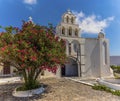 A panorama view across a courtyard towards the Virgin Mary church in Pyrgos, Santorini