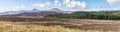 A panorama view across the rugged terrain on the island of Skye towards the flat topped mountains of MacCleods tables, Scotland