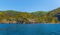 A panorama view along the Cinque Terre coast towards the village of Riomaggiore, Italy Royalty Free Stock Photo