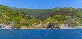 A panorama view along the coast towards the colourful Cinque Terre village of Vernazza Royalty Free Stock Photo