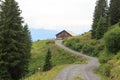 Panorama view in the alps with mountain hut and gravelled road in Salzburgerland, Austria Royalty Free Stock Photo