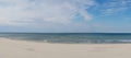 Panorama view of amazing white sand beach and calm ocean under an expressive sky