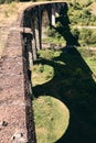 Panorama view of ancient bridge. Viaduct with old railway tracks near green hill of mountain forest. Locat travel concept Royalty Free Stock Photo