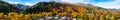 Panorama view of Arrowtown, New Zealand. Beautiful green yellow orange and red autumn trees with the town. I Royalty Free Stock Photo