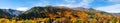 Panorama view of Arrowtown, New Zealand. Beautiful green yellow orange and red autumn trees with the town. I Royalty Free Stock Photo