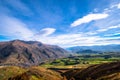 Panorama view of a beautiful road between Queenstown and Wanaka via Crown range. Grassland autumn trees with beautiful landscape Royalty Free Stock Photo