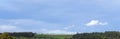 Panorama view Blue skyline with fram fields in spring or Summer, Landscape Green grass green trees with white Clouds and blue sky Royalty Free Stock Photo