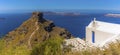 A panorama view of a cliffside chapel looking out over Santorini`s caldera towards Oia and Thirasia island Royalty Free Stock Photo