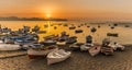 A panorama view of colourful fishing boats at Aspra Sicily as the sun sets over the Gulf of Palermo