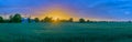 Panorama view of countryside with biogas plant on the background. Rapeseed field with agricultural factory in the countryside by s