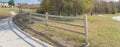 Panoramic long curved concrete pathway with wooden fence colorful fall foliage at park in Texas, USA Royalty Free Stock Photo