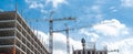 Panorama view double cranes working concrete building construction site, high-rise hotels, office building, skyscraper structure Royalty Free Stock Photo