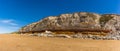A panorama view eastward along the white, red and orange stratified chalk cliffs of Old Hunstanton, Norfolk, UK Royalty Free Stock Photo