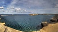 Panorama view of the entrance to the Valletta city harbor at Malta guarded by two lighthouses