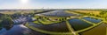 Panorama view of environmentally friendly installation of photovoltaic power plant and wind turbine farm situated by landfill.Sola Royalty Free Stock Photo