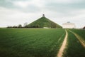 Famous Lions Mound memorial site at the battlefield of Waterloo with dark clouds, Belgium