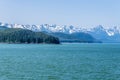 A panorama view of the forested islets and mountain backdrop of the Gastineau Channel on the approach to Juneau, Alaska Royalty Free Stock Photo