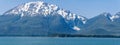 A panorama view of the forested shoreline and mountain backdrop of the Gastineau Channel on the approach to Juneau, Alaska Royalty Free Stock Photo