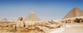 Panorama view of Giza in Cairo, the great pyramyd of Cheops, the pyramids of Kefren and Micerinos, the Sphinx Royalty Free Stock Photo