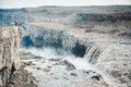 Hiker at gigantic Dettifoss waterfall in Iceland