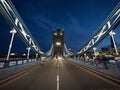 Panorama view of iconic illuminated famous Tower Bridge over Thames river in London England UK Great Britain at night Royalty Free Stock Photo