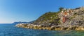 A panorama view from the landing stage across the breakwater towards the Cinque Terre village of Riomaggiore, Italy Royalty Free Stock Photo