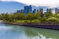 A panorama view long the edge of a lake in the Gardens by the Bay towards downtown Singapore, Asia