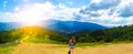 Panorama view of mountains. Girl in mountains. Hipster travelling. Beautiful landscape. Sky with clouds. Amazing nature. Royalty Free Stock Photo