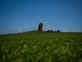 Panorama view of old rustic historic windmill Moulin de Moidrey in green grass field meadow Pontorson Normandy France