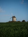 Panorama view of old rustic historic windmill Moulin de Moidrey in green grass field meadow Pontorson Normandy France