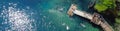 Panorama view people jumping off deck to magnitude turquoise blue water of Morrison Springs County Park in Walton County, Florida