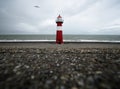 Panorama view of red white striped lighthouse tower Vuurtoren Noorderhoofd in Westkapelle Zeeland Netherlands North Sea Royalty Free Stock Photo