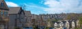 Panorama view residential street leading down a steep hill, row of two-story houses, new development subdivision neighborhood with Royalty Free Stock Photo