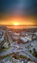 Panorama view of the road with a circular motion and a flower bed at sunset. Aerial photography.