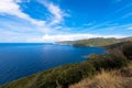 Panorama view of the rocky coastline of corsican Cap Corse near Erbalunga. Mediterranean landscape with maquis bushes in the foreg Royalty Free Stock Photo