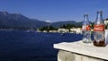 Panorama view of Rose Village with two empty glass bottles of Coca Cola - August 6, 2019, Kotor Bay, Montenegro, Europe