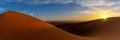 panorama view of the sand dunes at Erg Chebbi in Morocco at sunset with a sunstar Royalty Free Stock Photo