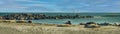 Panorama view of sea landscape with grey seals lying on beach and sailing boat DÃÂ¼ne Heligoland island. Royalty Free Stock Photo