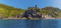 A panorama view from the sea passing the castle hill in the Cinque Terre village of Vernazza