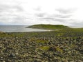 A panorama view of a sea shore with stones