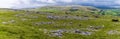 A panorama view showing glacial erratics deposited on the limestone pavement on the southern slopes of Ingleborough, Yorkshire UK Royalty Free Stock Photo