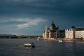 Panorama view of swimming boats along River Danube near the Budapest Parliament and Chain Bridge. Budapest, Hungary