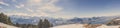 Panorama view of Swiss Alps mountai in winter with forest and blue sky Royalty Free Stock Photo