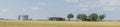 Panoramic Texas farm house with large storage tower silo in farmyard prairie Royalty Free Stock Photo