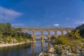 Panorama view to the limestone Pont du Gard three-tiered aqueduct at the river Gardon.