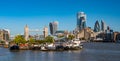 Panorama view of the Tower bridge over Thames river on a sunny day with wharf and boats. City Financial district skyscrapers Royalty Free Stock Photo