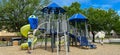 Panorama view unidentified Asian lady in short jeans, outdoor hat helping her toddler girl daughter climbing up playground